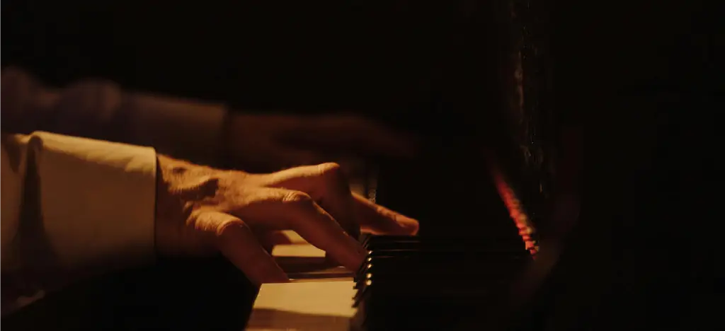 A pianist playing in almost complete darlness. It allows you to focus on your playing