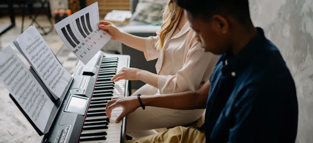 A teenager having a piano lesson