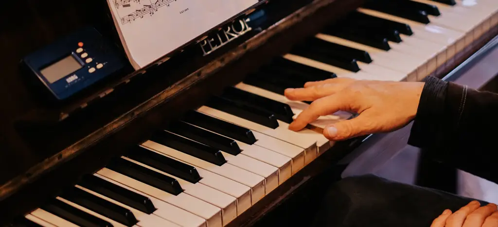 piano Close-up of a piano with a slightly worn/used feel: hands improvising