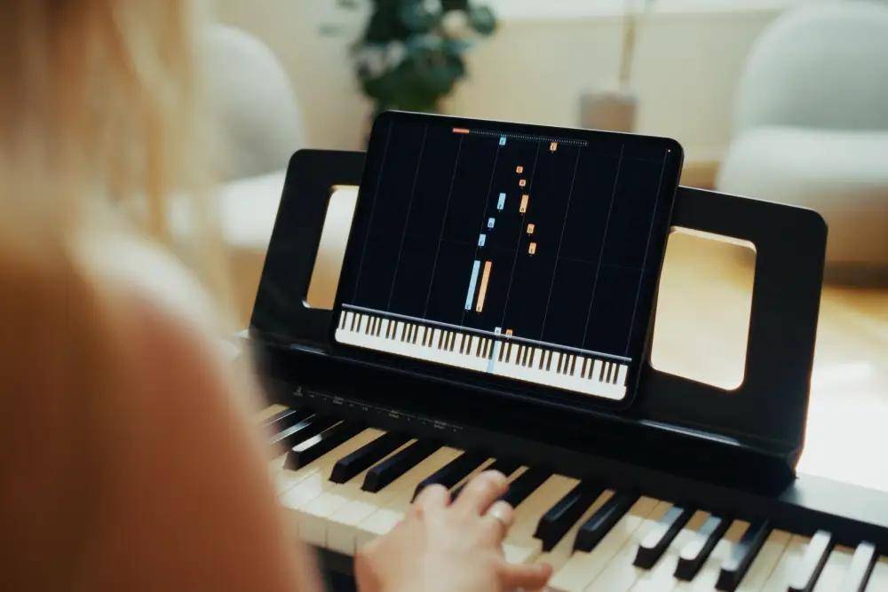 Woman learning piano with Artie AI piano teacher, using real-time feedback