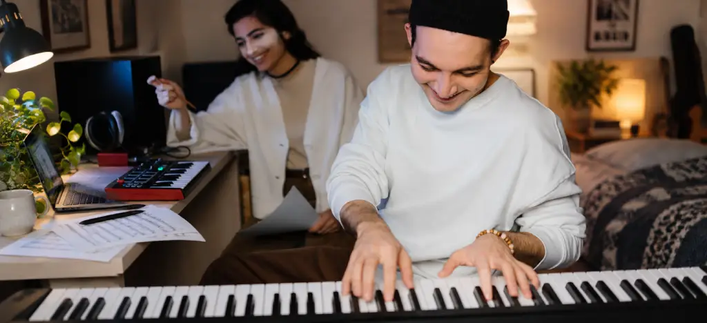 Two people playing and learning piano at home